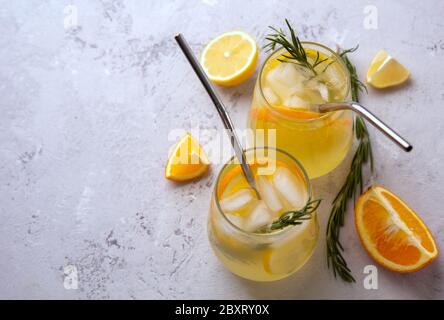 Cold lemonade with citrus in glass glasses with ice. Top view, place for text. Stock Photo