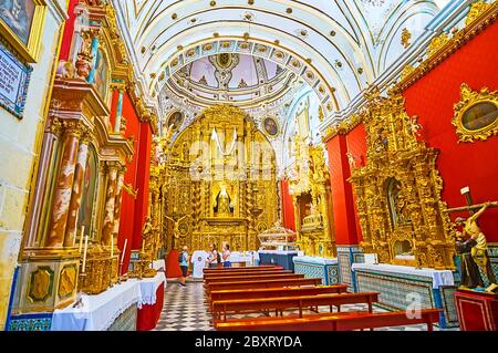 ARCOS, SPAIN - SEPTEMBER 23, 2019: Ayflones Chapel of San Pedro Church with gilt plateresque altarpiece, decorated with Solomonic columns, intricate r Stock Photo