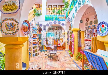 ARCOS, SPAIN - SEPTEMBER 23, 2019: Interior of art gallery with local handicrafts - decorative ceramic wall plates, small tiles, figurines, on Septemb Stock Photo