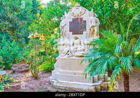 CADIZ, SPAIN - SEPTEMBER 23, 2019: The lush greenery of Genoves park hides stone memorial of Duchess Victoria, on September 23 in Cadiz Stock Photo