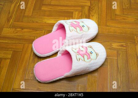Childlike slippers on parquet Stock Photo