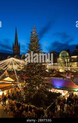 Huge decorated Christmas tree during Xmas fair on the market place in front of town hall in Lübeck / Luebeck, Schleswig-Holstein, Germany Stock Photo