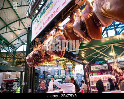 Legs of ham display Borough Market Stall hams air curing on display for sale and selling at Festive Christmas Borough Market  butchers stall Southwark London UK Stock Photo