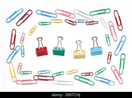 Colorful metal paper clips and pins stationery arranged in square on white background Stock Photo