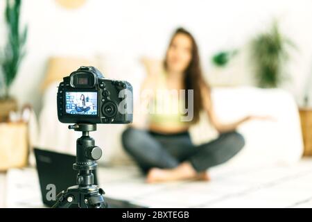 .Woman sports blogger is recording a video. Stock Photo