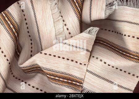 Linen kitchen napkins close-up. Light napkins made of natural fabric with a pattern and fringe. Restaurant business background. Selective focus. Stock Photo