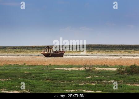 Old fishing schooner at the bottom of the dried Aral Sea Stock Photo