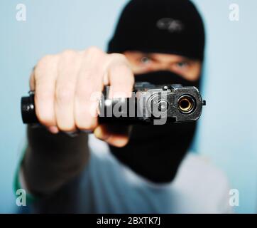 man with a gun on his hand Stock Photo