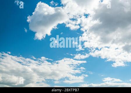 Beautiful clouds on the clear blue sky and sun Stock Photo