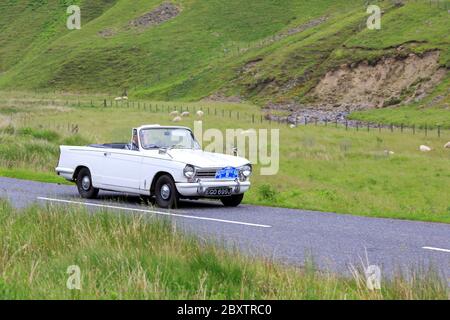 MOFFAT, SCOTLAND - JUNE 29, 2019: 1970 Triumph Herald 13/60 car in a classic car rally en route towards the town of Moffat, Dumfries and Galloway Stock Photo