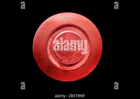 Push red button, isolated on black background Stock Photo