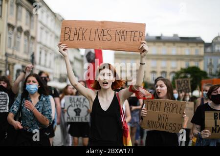 Cracow, Lesser Poland, Poland. 7th June, 2020. A young woman holds a placard reading 'Black Lives Matter' during the protest.Hundreds of young people took part in 'Black Lives Matter' protest in Cracow, the biggest city in southern Poland. They paid tribute to George Floyd and expressed their disapproval of police brutality and racism. Credit: Filip Radwanski/SOPA Images/ZUMA Wire/Alamy Live News Stock Photo