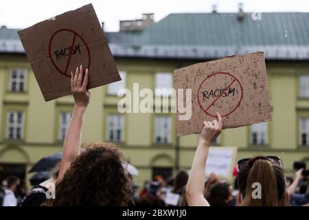 Cracow, Lesser Poland, Poland. 7th June, 2020. Protesters hold placards with slogans condemning racism during the Black Lives Matter protest.Hundreds of young people took part in 'Black Lives Matter' protest in Cracow, the biggest city in southern Poland. They paid tribute to George Floyd and expressed their disapproval of police brutality and racism. Credit: Filip Radwanski/SOPA Images/ZUMA Wire/Alamy Live News Stock Photo