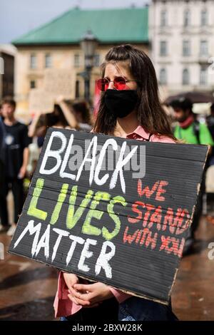 Cracow, Lesser Poland, Poland. 7th June, 2020. A protester wearing a facemask is seen holding a placard reading Black Lives Matter during the protest.Hundreds of young people took part in 'Black Lives Matter' protest in Cracow, the biggest city in southern Poland. They paid tribute to George Floyd and expressed their disapproval of police brutality and racism. Credit: Filip Radwanski/SOPA Images/ZUMA Wire/Alamy Live News Stock Photo