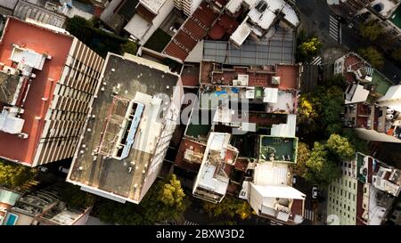 Aerial view of rooftops in different colors, height, surroundings, settings surrounded by autumn trees, Palermo, Buenos Aires, Argentina. Stock Photo