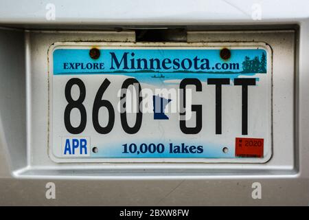 Close up of fictitious digits on a Minnesota state License plate, with cutout and clip art, along with slogan, Explore Minnesota and 10,000 lakes, MN Stock Photo