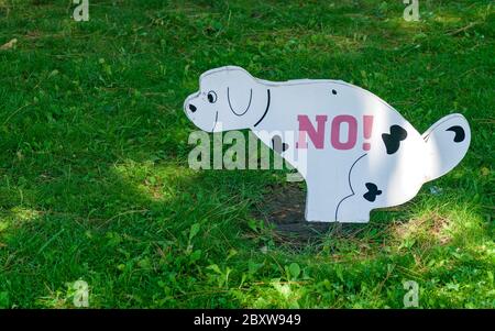 Prohibition of dog walking on green grass of lawn Stock Photo