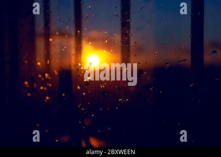 rain drops on the glass ,view of sunset sunbeam through the window Stock Photo