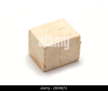 Fresh whole yeast block over white background. Stock Photo