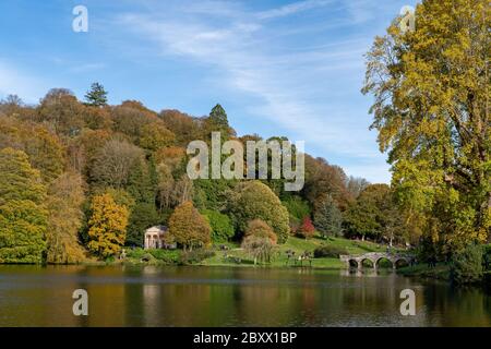 View of the autumn colours around the lake at Stourhead gardens in Wiltshire. Stock Photo