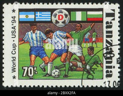 TANZANIA - CIRCA 1994: stamp printed by Tanzania, shows soccer players and ball, circa 1994. Stock Photo