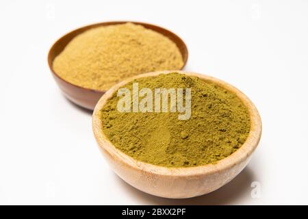 Henna powder in a wooden bowl. Natural hair care. Henna hair dye. Stock Photo