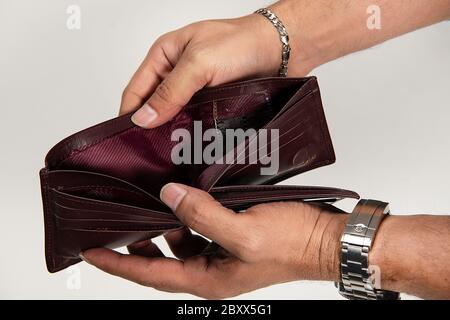 Man hand open an empty wallet isolated on white background. Stock Photo
