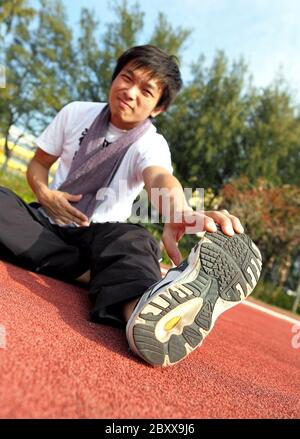 man doing stretching exercise Stock Photo