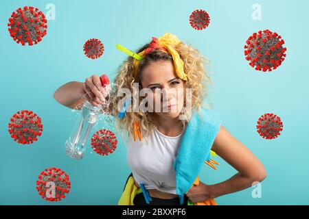 Funny housewife cleans and disinfects to keep germs, viruses and bacteria away. Stock Photo
