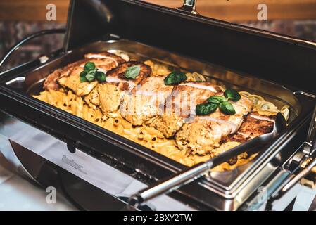 Row of stainless hotel pans on food warmers. Warm vegetable as side dishes.  Self-service buffet table. Celebration, party, birthday or wedding concept  Stock Photo - Alamy