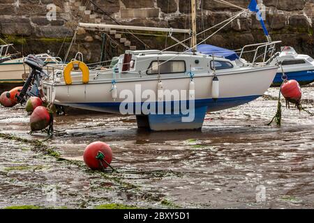 Boats at low tide in Scarborough harbour, England, UK Stock Photo