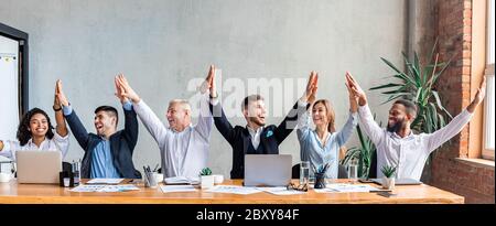 Business Colleagues Giving High-Five Celebrating Success Sitting In Office, Panorama Stock Photo