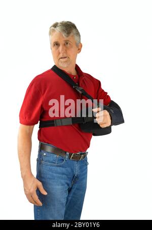 Middle aged man wearing a shoulder surgery sling with abduction pillow to keep his arm in the proper position during recovery and healing after his op Stock Photo Alamy