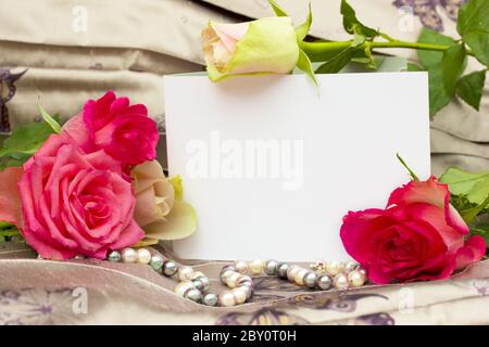 roses with pearls strand and blank card Stock Photo