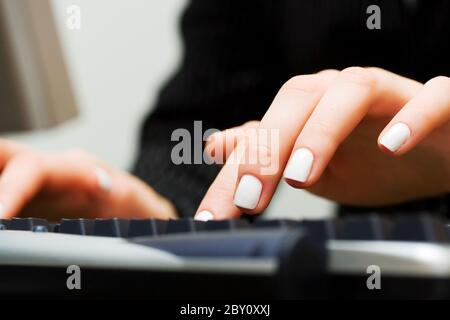 Female hands typing on computer keyboard Stock Photo