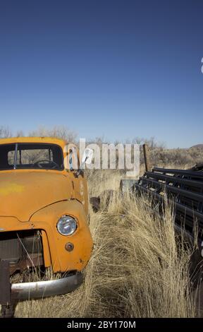 Old abandoned orange truck Stock Photo