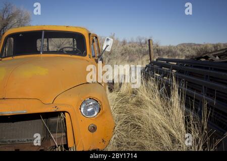 Old abandoned orange truck Stock Photo
