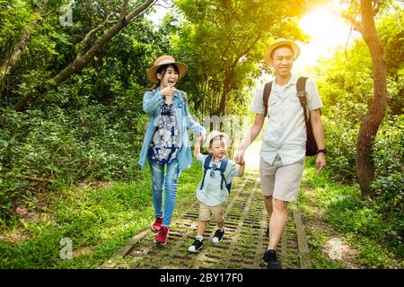 happy family hiking through the forest Stock Photo