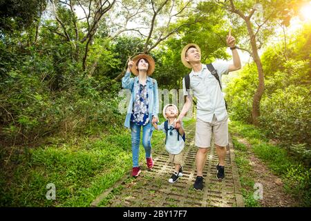 happy family hiking through the forest Stock Photo