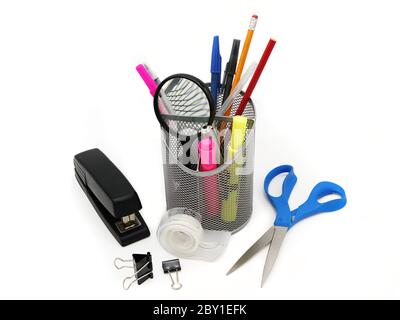 Desk item including stapler, pens, scissors, tape and binder clips. Stock Photo