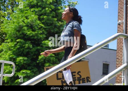 Solo Black young female speaking at Black Lives Matter Protest on stairs crying - ridgefield park, bergen county, new jersey, usa monday june 8th 2020 Stock Photo