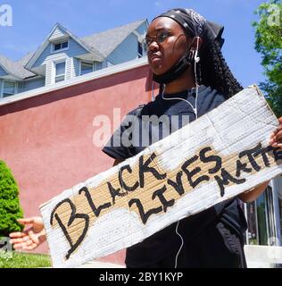 Young Black Female Holding Black Lives Matter Sign at Black Lives Matter George Floyd Protest in Ridgefield Park, New jersey, bergen county, USA Monda Stock Photo