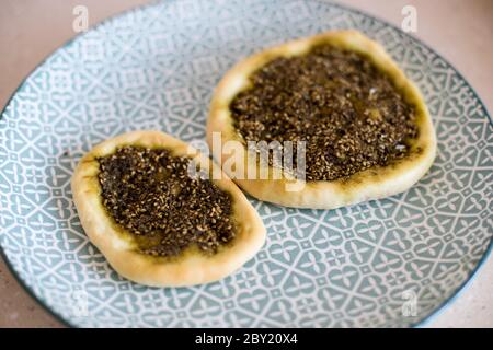 Close up photo of Manaqish b'il Za'atar, a popular Leventine dish commonly attributed to Arabian cuisine. Stock Photo