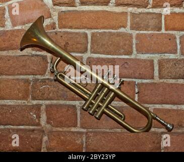 Trumpet on brick wall background Stock Photo