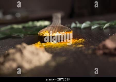 Beautifully garnished food ingredients on table top include various spices like chilly, lemon, curry leaves, ginger, garlic, prawns, spoons etc. Stock Photo