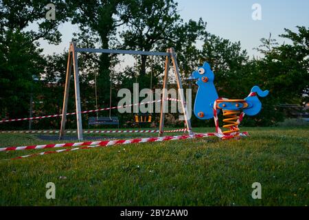 Swing in restricted area playground in Italy Stock Photo
