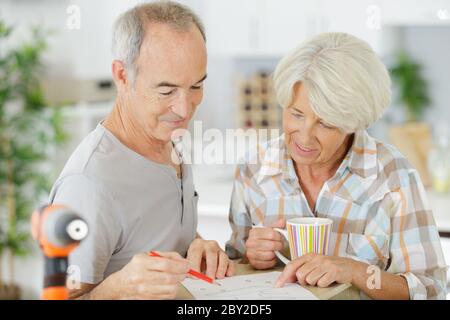 senior couple doing home renovations Stock Photo