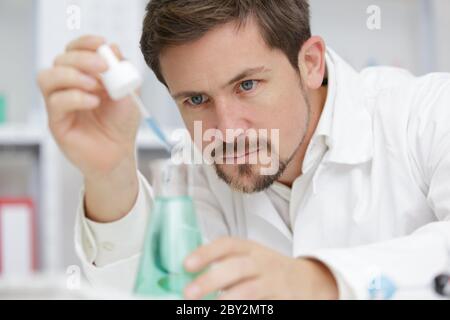 young male scientist doing experiments in laboratory Stock Photo