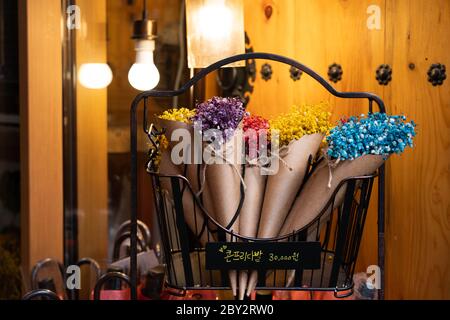 Colorful bouquet of flowers on a black shelf and wooden background Stock Photo