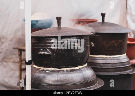 Close up image of large Korean traditional ceramic rice cooker with smoke coming out. Korean stone pot. Stock Photo